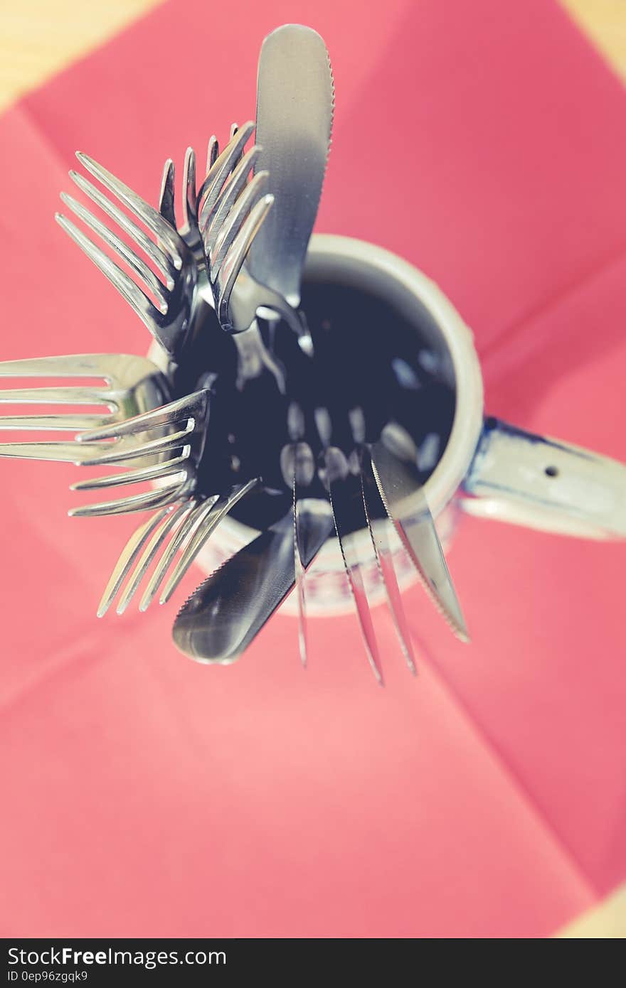 Silver Steel Utensils Inside White Ceramic Mug