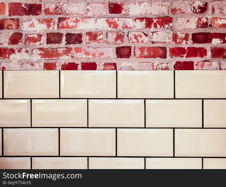 White Ceramic Wall Tile Beside Red Concrete Bricks