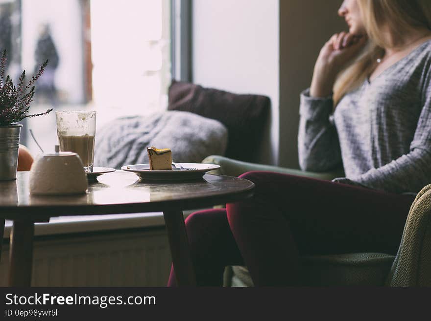 Photography of Woman Near Round Table during Daytime