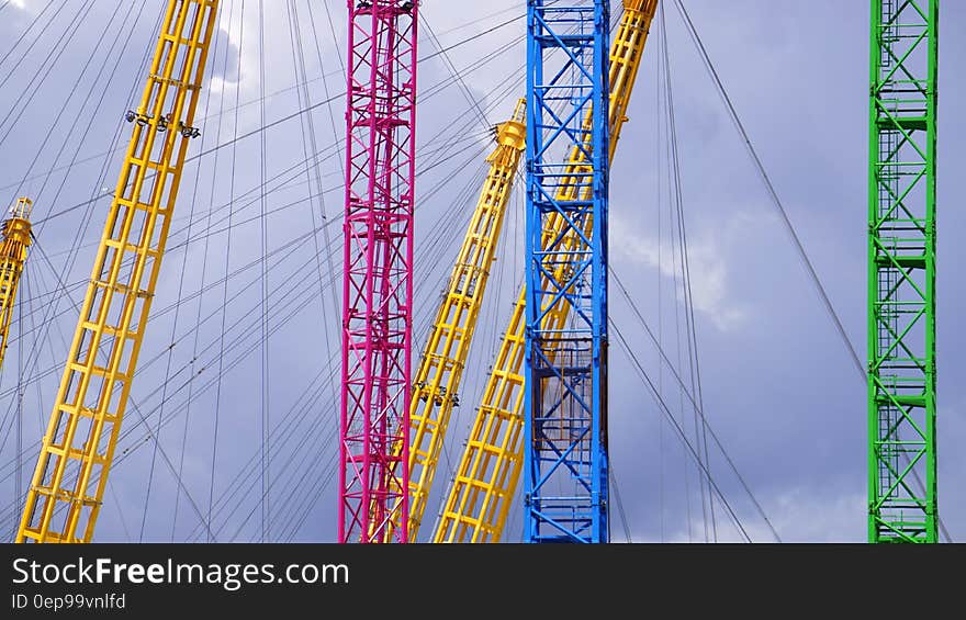 Blue Yellow Red and Green Metal Bar With Metal Sprint in Low Angle Photography