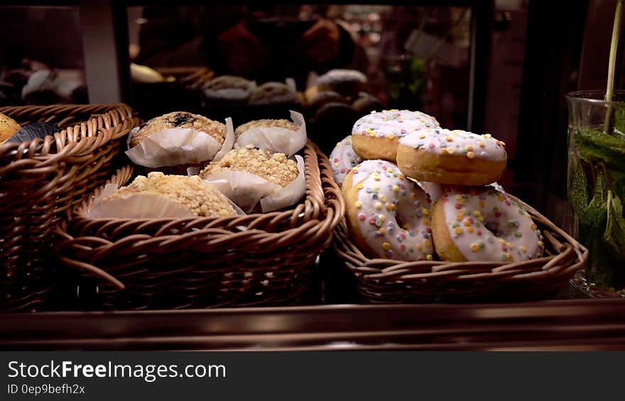 White Topped Doughnut Beside Peanut Cupcake