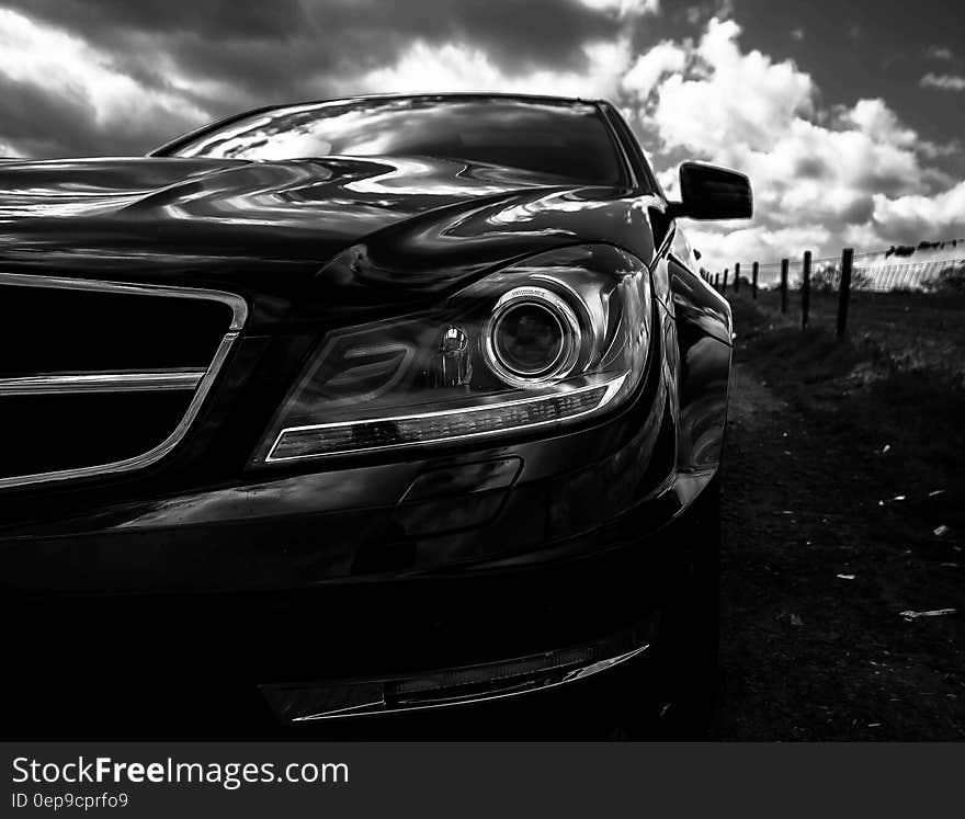 Gray Scale Photo of Car on Side of the Road