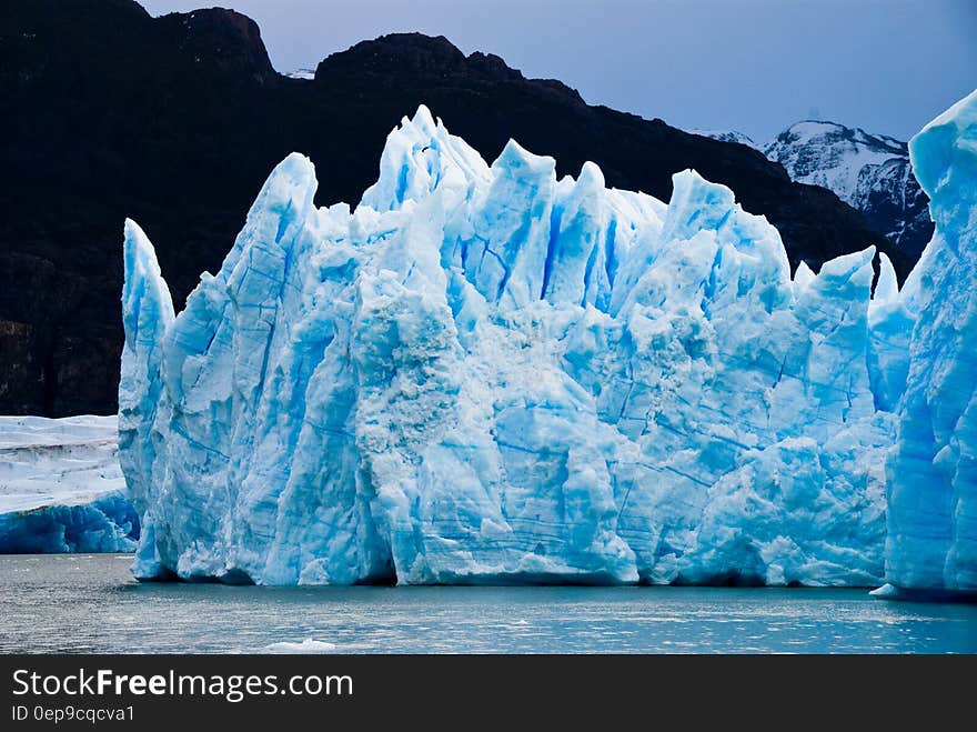 Ice Burg Floating on Water during Daytime