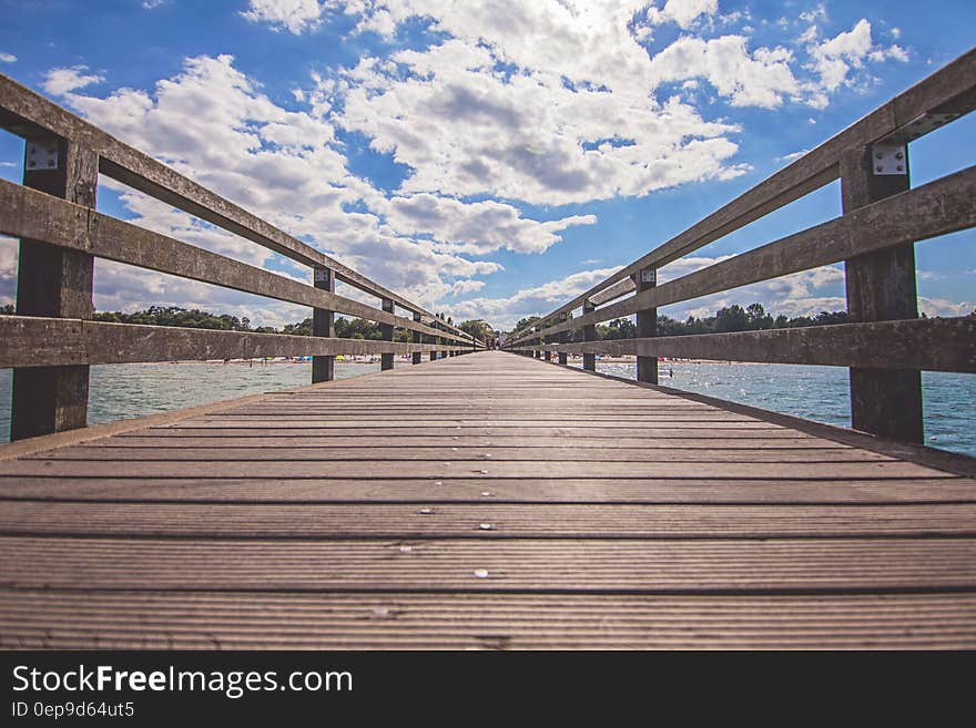 Empty boardwalk leading to seashore on sunny day. Empty boardwalk leading to seashore on sunny day.