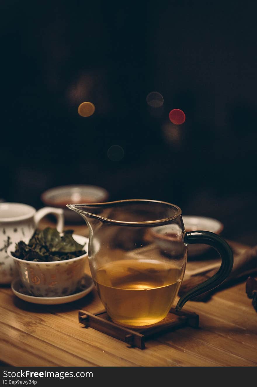 Clear Glass Cup on Brown Wooden Table