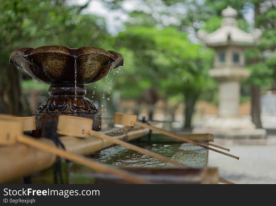 Water fountain with dippers outside stone pagoda. Water fountain with dippers outside stone pagoda.