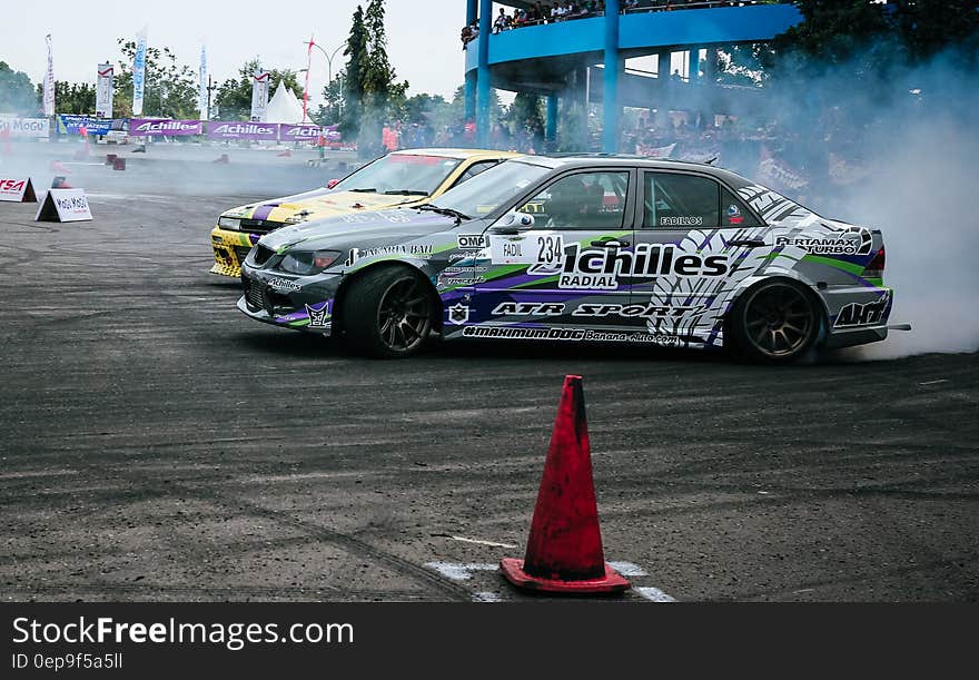 Gray and White Racing Car Drifting