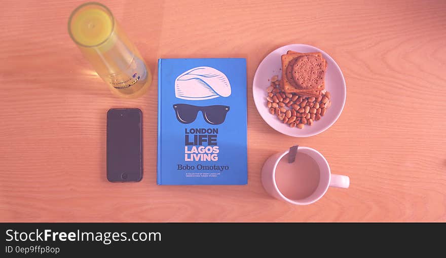 Peanuts and Biscuits in White Ceramic Plate Beside White Ceramic Mug Near Lagos Living Book