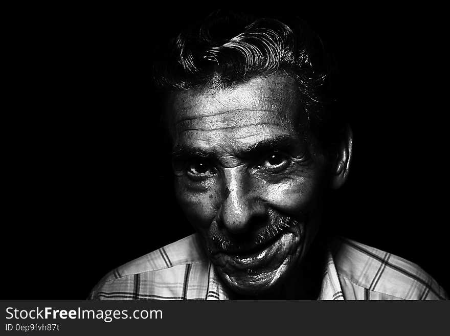 Grayscale Photo of Man Smiling