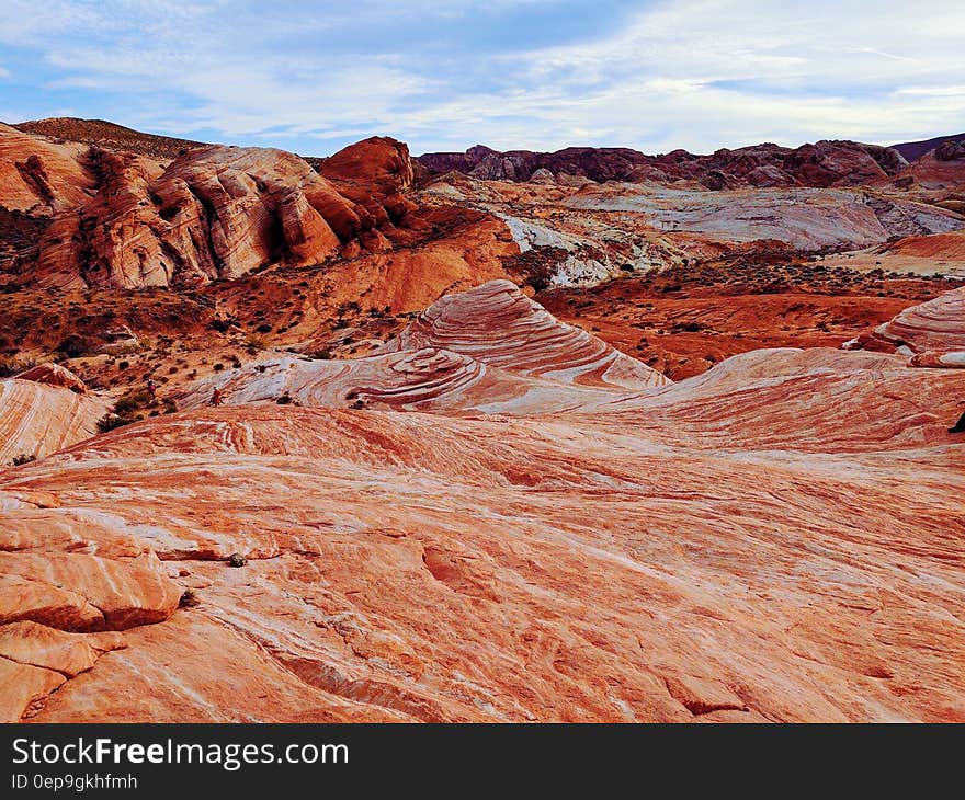 Brown and White Mountain Under Blue and Cloudy Sky