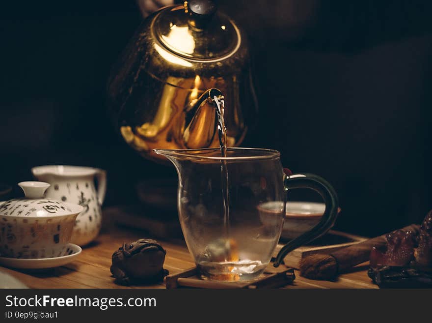 Gold Steel Kettle Beside Clear Glass Pitcher