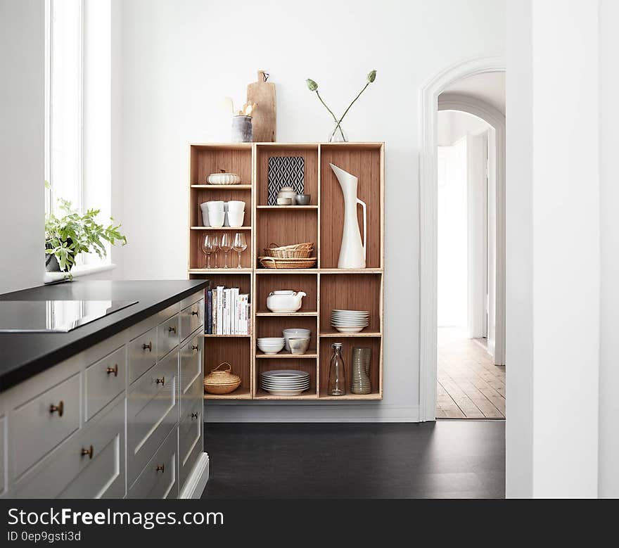 Interior of stylish modern home with chest of drawers and and cupboard style shelves with decoration ornaments. Interior of stylish modern home with chest of drawers and and cupboard style shelves with decoration ornaments.