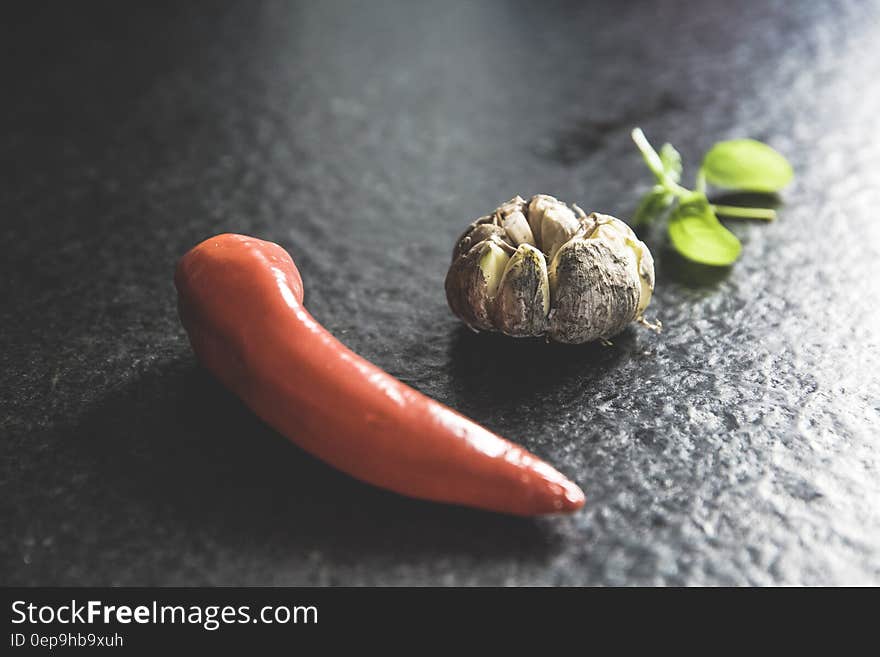 Red Chili Beside Brown Bead and Green Leaf