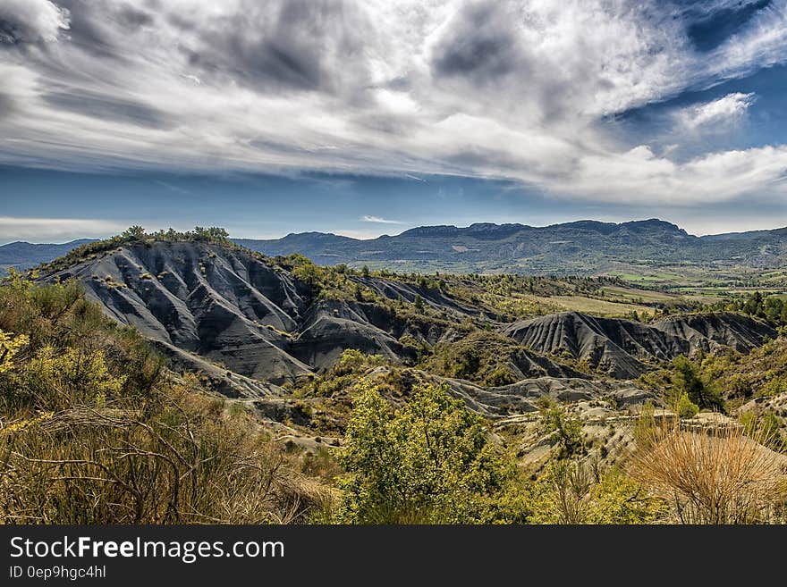 Green and Gray Mountain Under White and Blue Sky