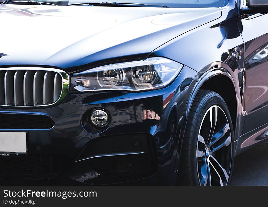 Front fender and grill of black luxury car. Front fender and grill of black luxury car.