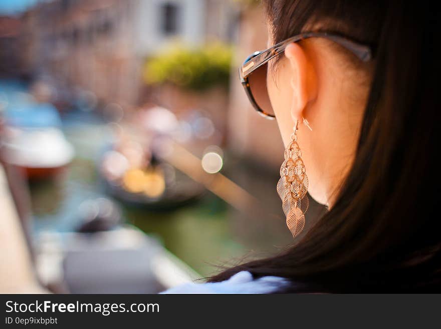 Woman Wearing Pendant Earrings and Sunglasses