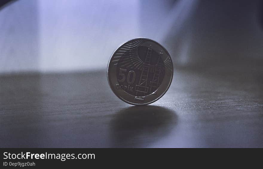 Close up of silver coin on tabletop.