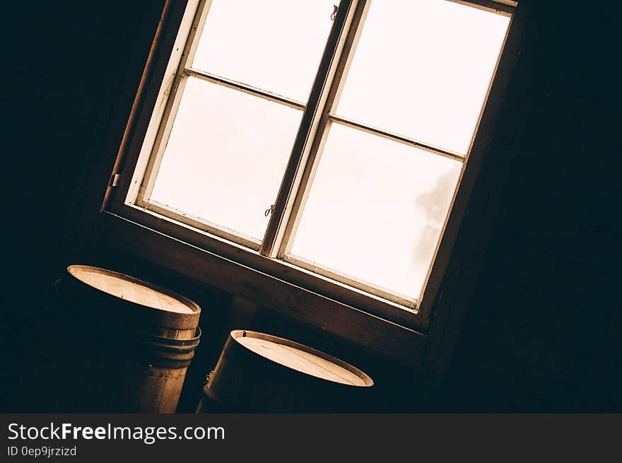 Wooden barrels inside by sun filled windows. Wooden barrels inside by sun filled windows.