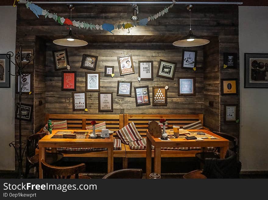 Dinning Tables Near Wall With Photo Frame Decor