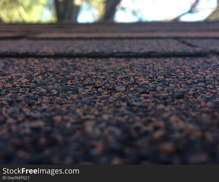 Close up of black and tan stones in road surface. Close up of black and tan stones in road surface.