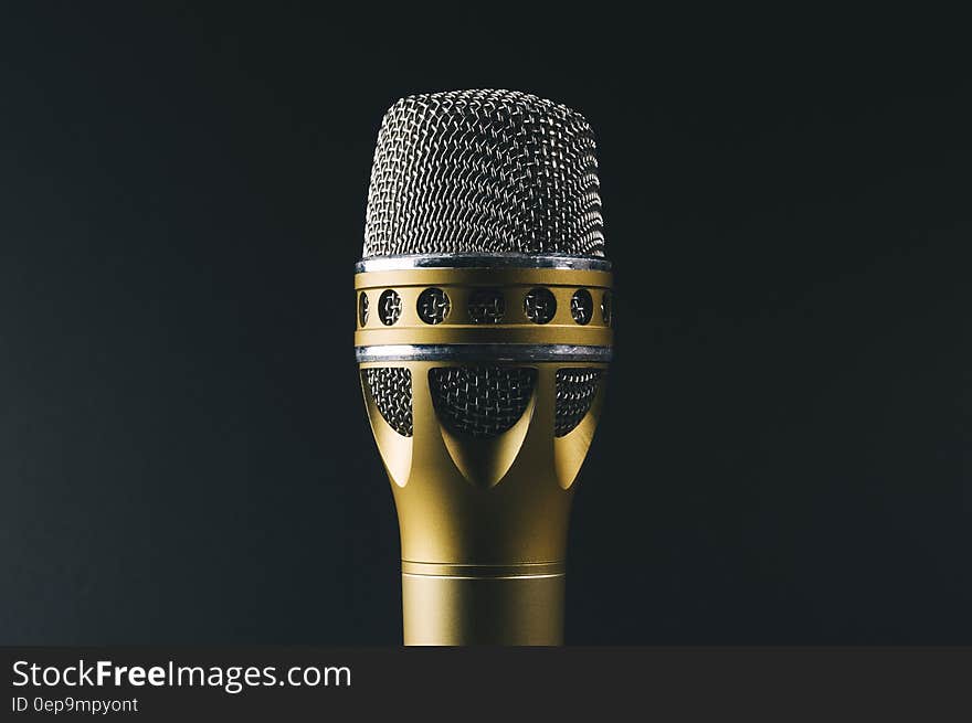 Vintage chrome and gold microphone on black. Vintage chrome and gold microphone on black.