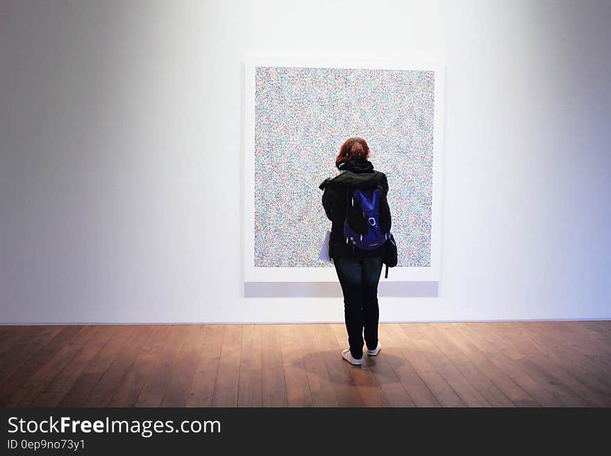 Woman Standing Infront of a Wall Mount Painting