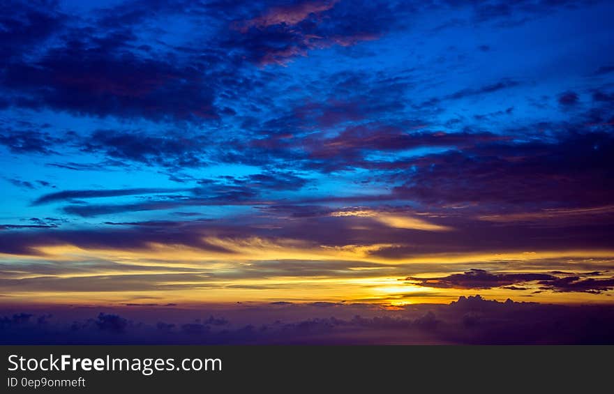 Blue and gold skies on horizon at sunset. Blue and gold skies on horizon at sunset.