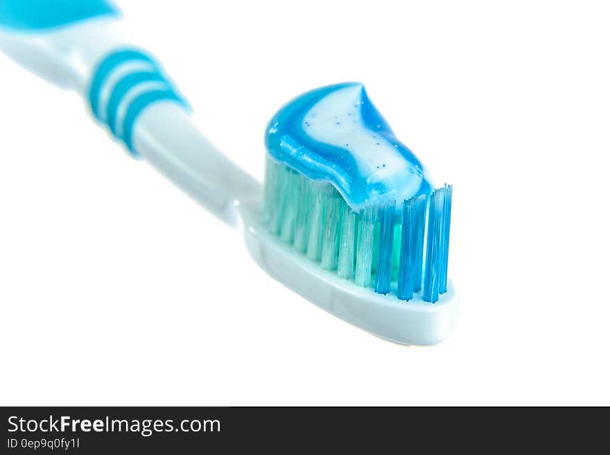 Blue and White Toothpaste on Toothbrush