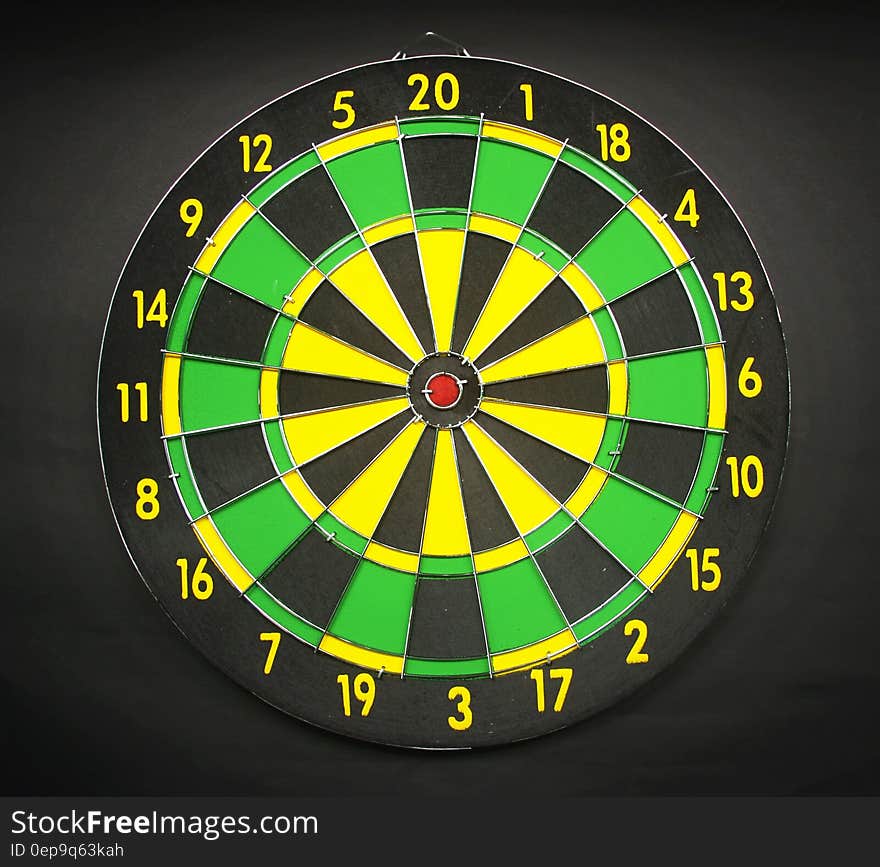 Green Yellow and Black Round Dart Board With Black Background