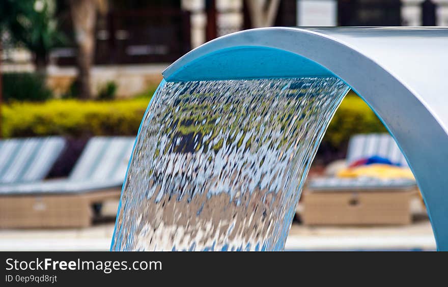 Close up of fountain in resort pool on sunny day.