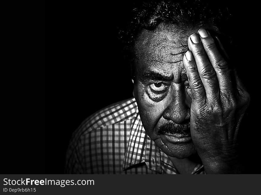 Greyscale Photo of Man in Collared Shirt Covering Left Eye