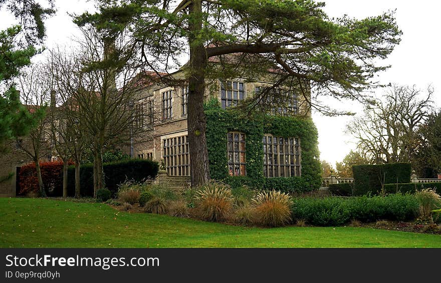 Exterior of stately home and ground on sunny day. Exterior of stately home and ground on sunny day.