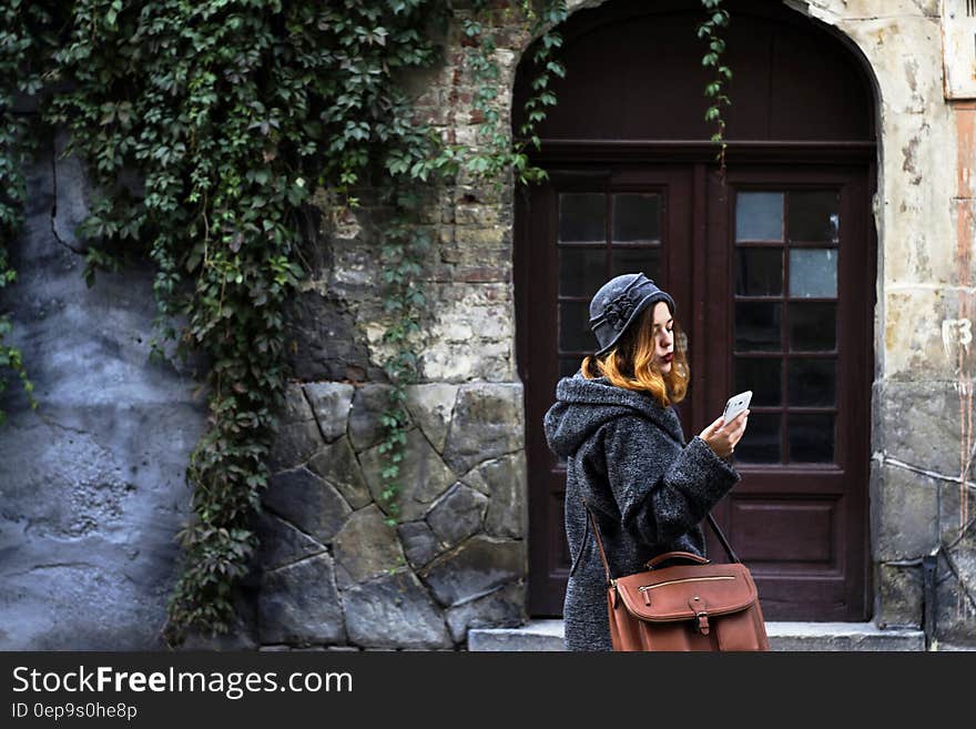 Woman Sitting in Front of Building