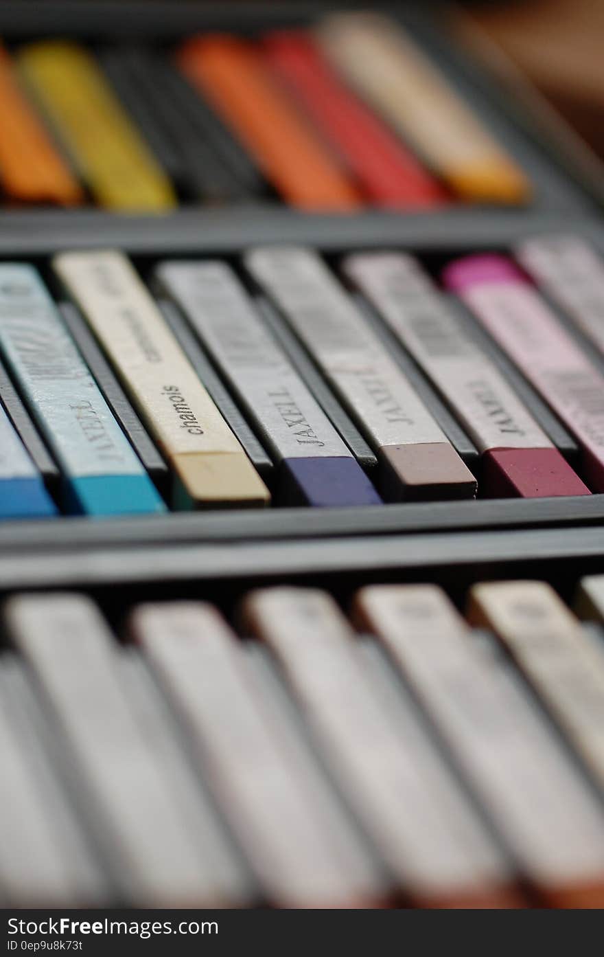 A close up of a palette of different crayon colors.