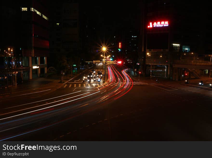 Streaks of headlights and taillights on city streets at night.