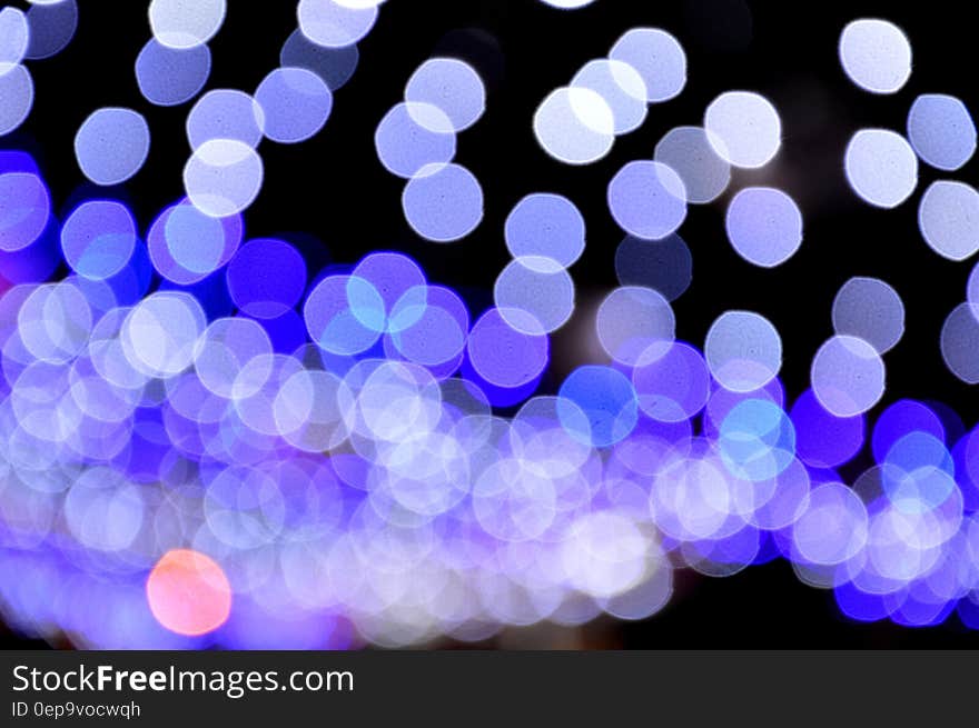 Blue bokeh lights on black background.