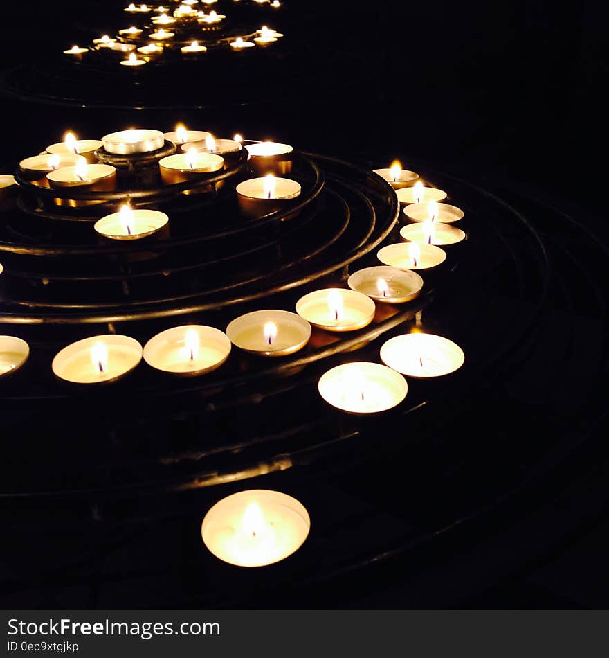 Illuminated Candles on Black Background