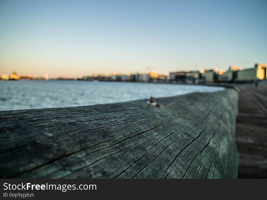 Close up of railing along wooden waterfront boardwalk at twilight. Close up of railing along wooden waterfront boardwalk at twilight.