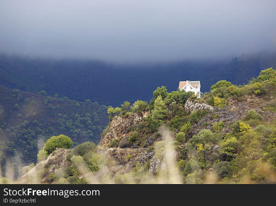 White House on Mountain during Cloudy Day