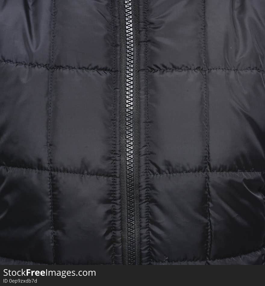 Close Up Shot of Black Zip Up Quilted Textile