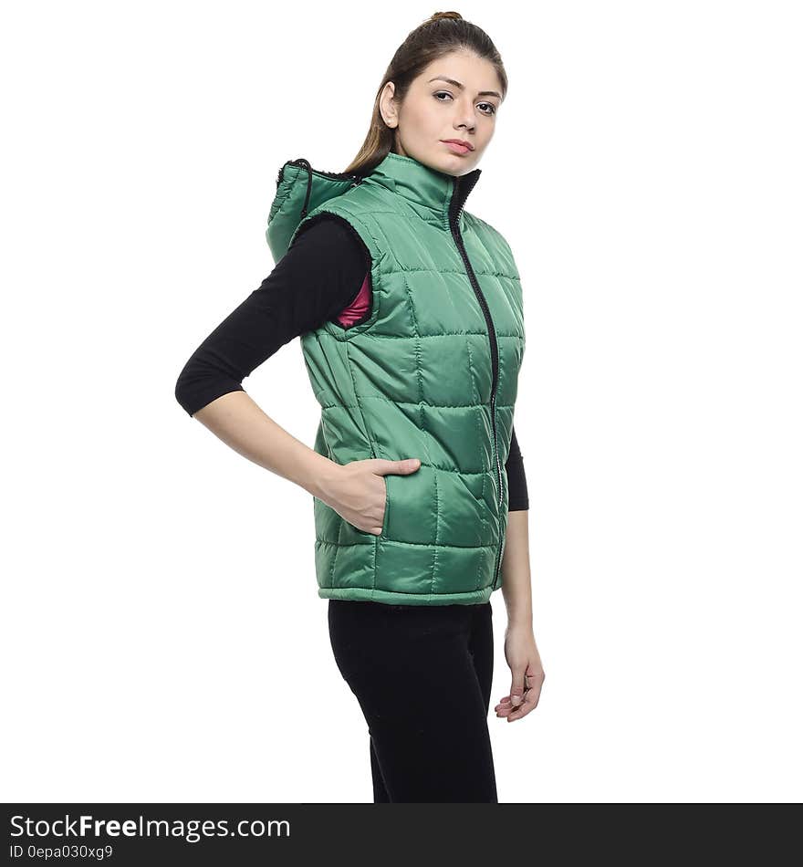 Woman Wearing a Green Puffer Vest and a Black Pants