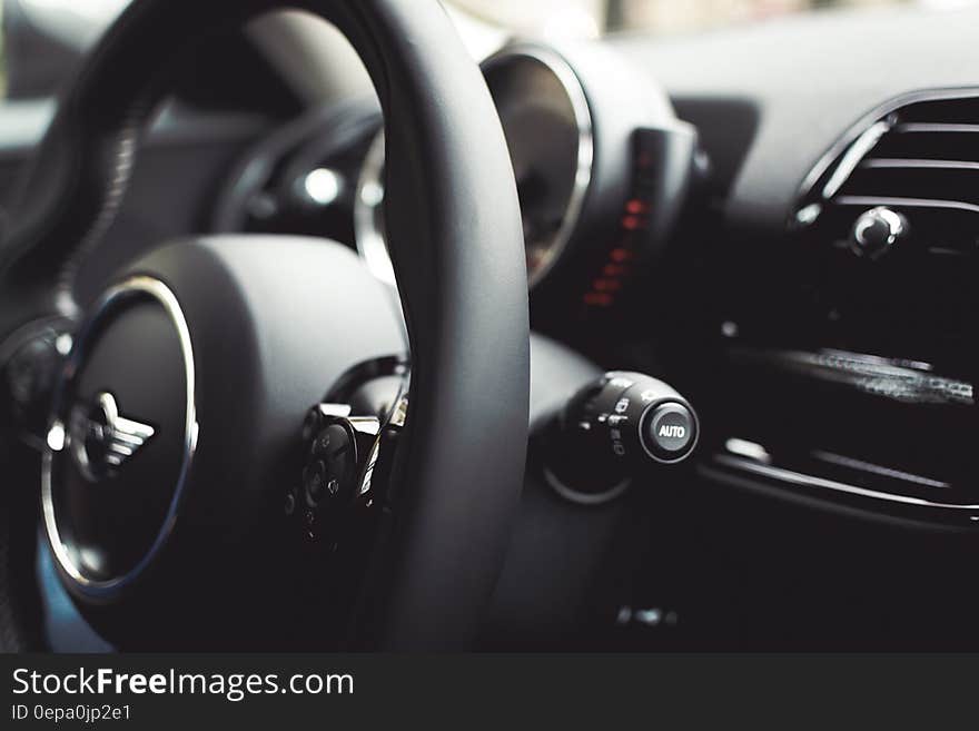 Close up of black leather steering wheel inside luxury Cooper automobile. Close up of black leather steering wheel inside luxury Cooper automobile.