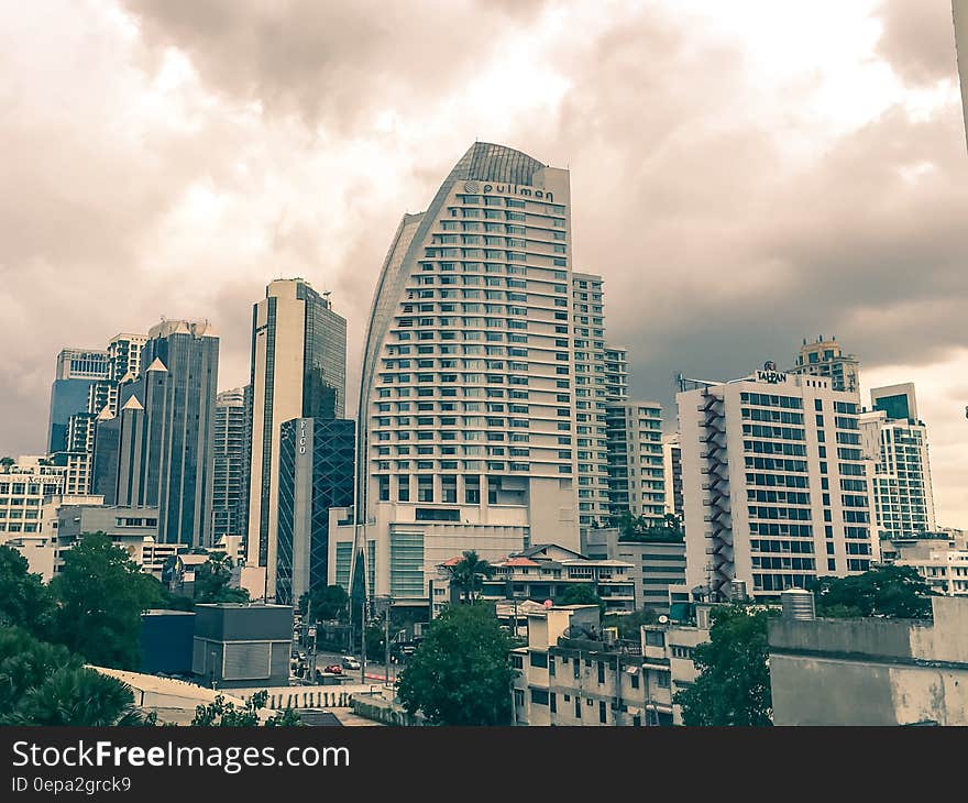 Modern architecture in financial district of city against cloudy skies. Modern architecture in financial district of city against cloudy skies.