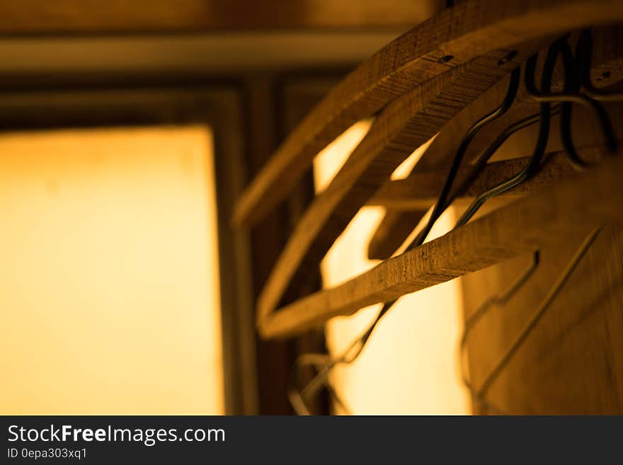 Closeup of wooden furniture hangers in closet with copy space.