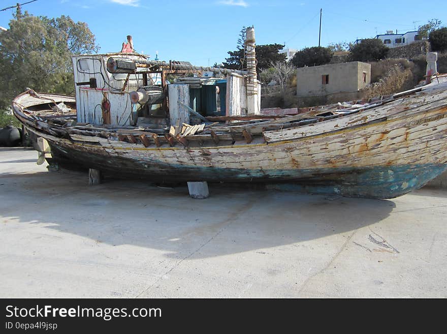 Wreck of wooden boat in dry dock.