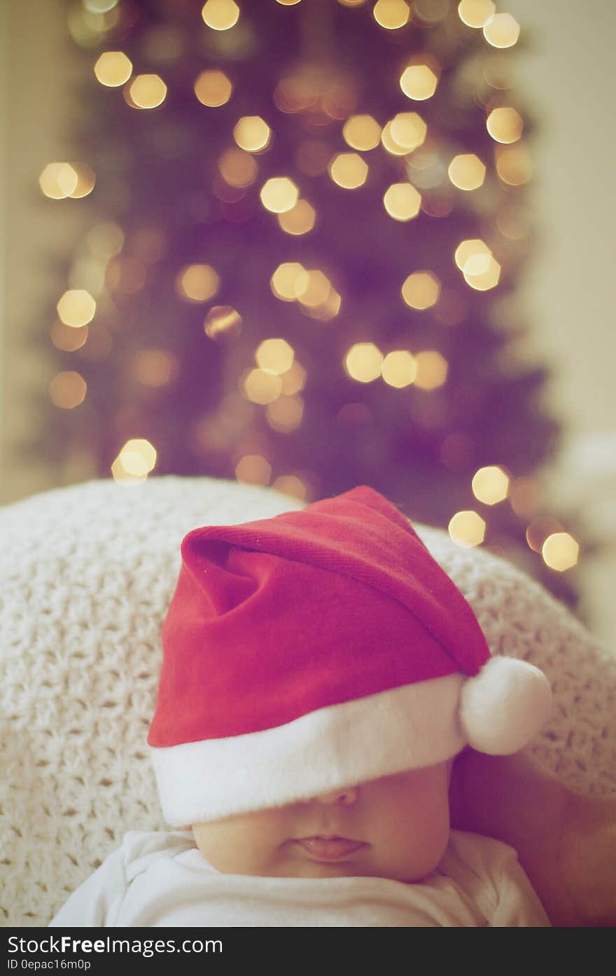 Close-up of Illuminated Christmas Tree And A Baby