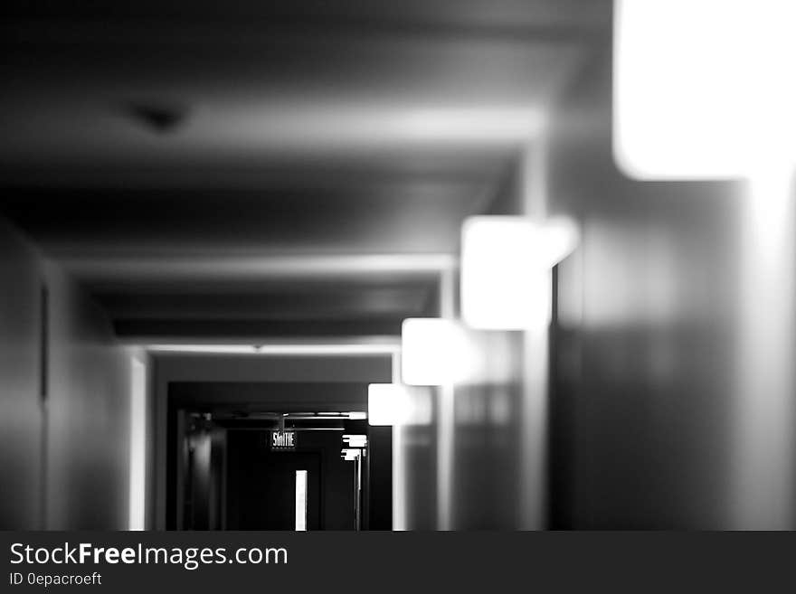 Lights along corridor inside building in black and white. Lights along corridor inside building in black and white.