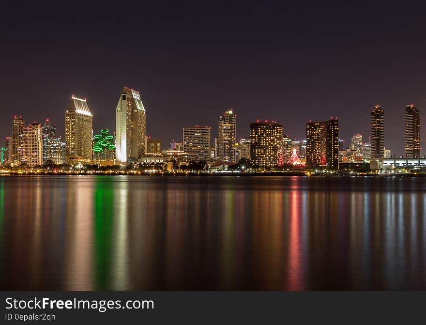 Lights from city skyline reflecting in waterfront at night. Lights from city skyline reflecting in waterfront at night.