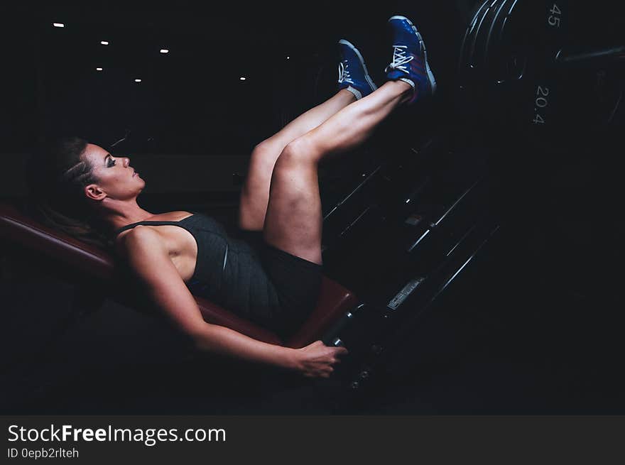 Portrait of woman training in dark gym. Portrait of woman training in dark gym.