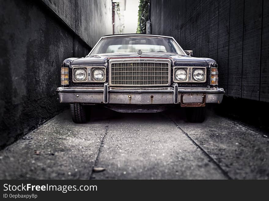 Front of vintage car in narrow alleyway. Front of vintage car in narrow alleyway.